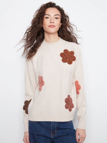 Sophisticated sweater emphasizing detailed floral appliqués that enhance its overall fashionable appearance. By Charlie B.