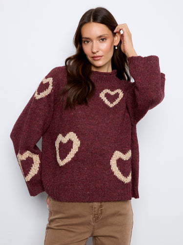 Charming sweater with a mock neck and heart patterns, perfect for cozy afternoons. The relaxed fit enhances comfort. By Charlie B.
