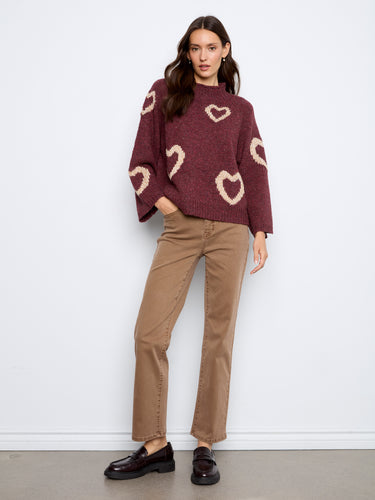 Stylish knitwear with a relaxed fit and charming hearts, offering both warmth and style for casual outings. By Charlie B.
