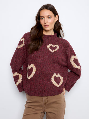 Cozy sweater with intricate heart motifs and a comfortable mock neck, great for everyday wear. By Charlie B.