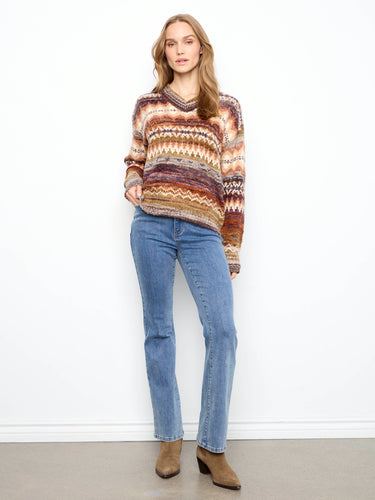 Long sleeves add warmth and versatility to this colorful patterned sweater, making it a great choice for cooler days by Charlie B.