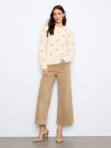 Soft long sleeves provide warmth and comfort in this stylish piece. Ideal for any casual outing. By Charlie B.