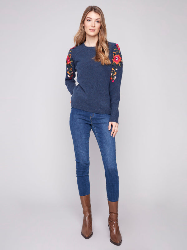 Chic heather denim sweater adorned with embroidered flowers along raglan sleeves by Charlie B.