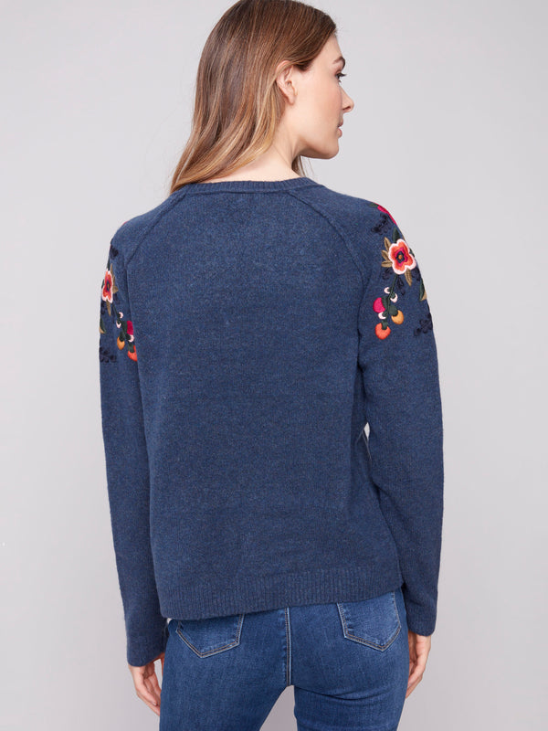 Elegant heather denim sweater with intricate embroidered raglan sleeves for a unique look by Charlie B.