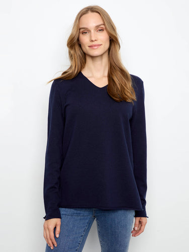 A soft knit sweater featuring a flattering V-neckline, perfect for layering or wearing alone. By Charlie B.