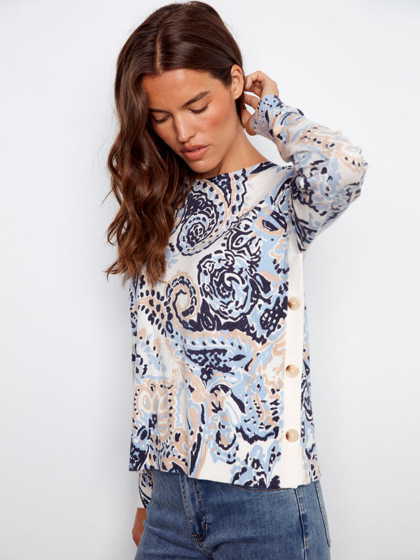 Stylish long-sleeve sweater featuring elegant side buttons and a unique abstract design by Charlie B.