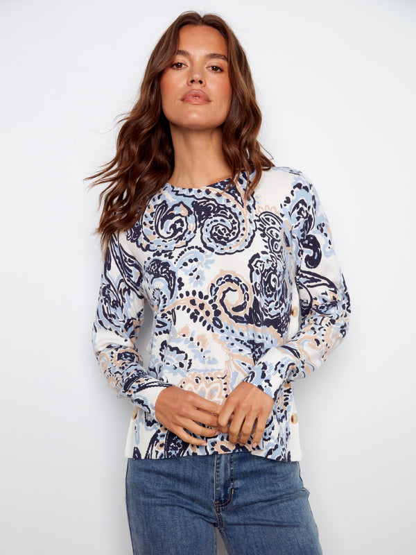 This eye-catching sweater combines a crew neck with an abstract Rococo pattern for a chic look by Charlie B.