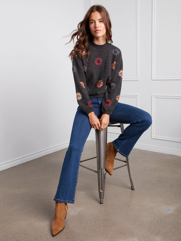 Chic charcoal sweater highlighted by vibrant floral embroidery and comfortable elastic cuffs by Charlie B.