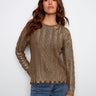 Cable knit sweater featuring a metallic finish in spruce, perfect for adding shine to your wardrobe. By Charlie B.