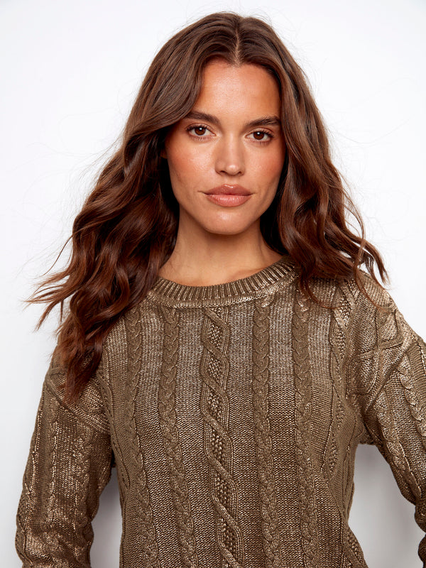 Spruce sweater with a unique ripped hem effect, offering a stylish twist on classic knitwear. By Charlie B.
