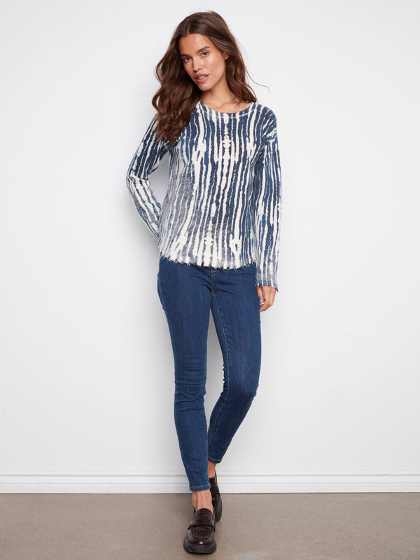 Cozy plush sweater in blue and white with a classic crew neckline that enhances its timeless appeal by Charlie B.