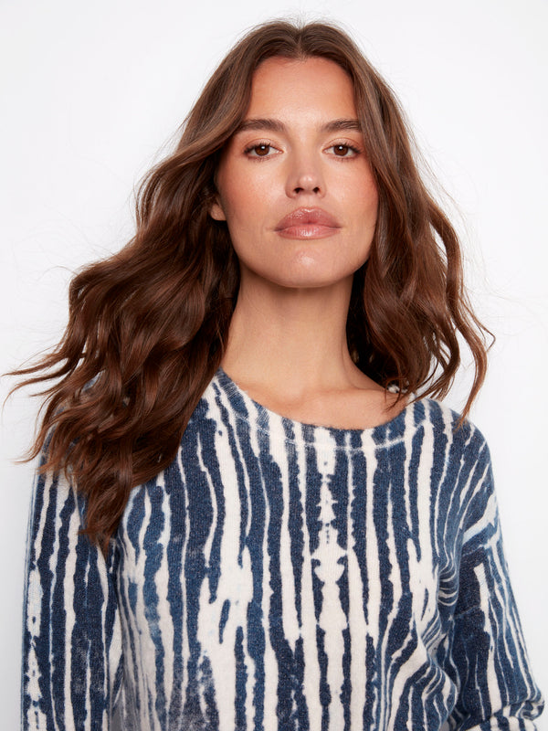 Printed plush sweater in blue and white showcasing frayed edges for an edgy look by Charlie B.