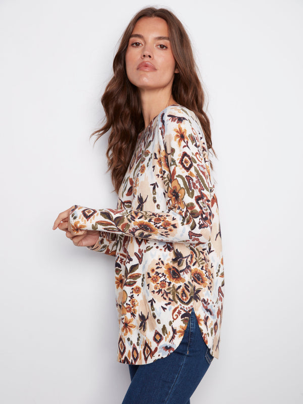 Floral patterned sweater with side slits for added comfort and style versatility by Charlie B.