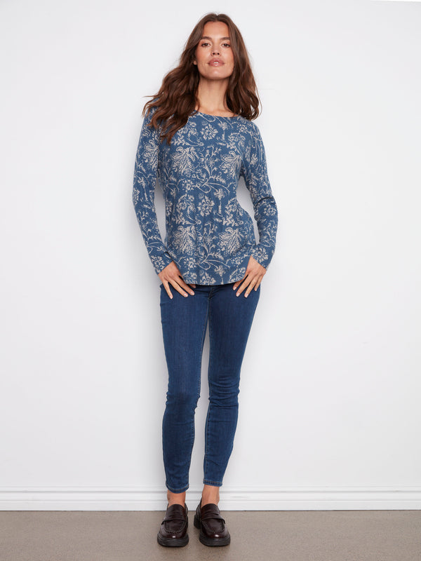 Elegant calico blue sweater with ribbed sleeves and intricate floral patterns by Charlie B.