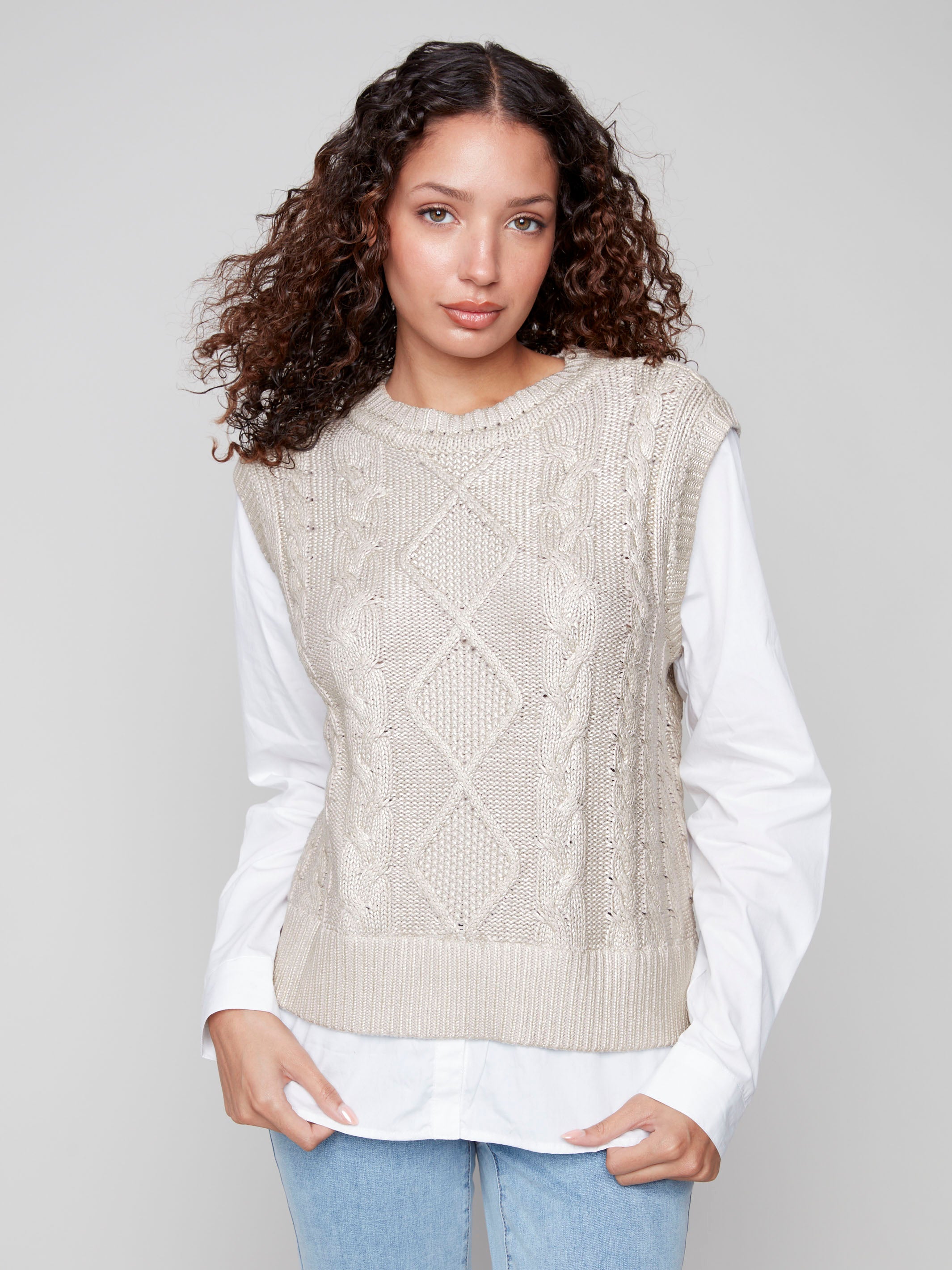Stylish cable knit sweater vest in gold foil, featuring intricate patterns and timeless appeal by Charlie B.