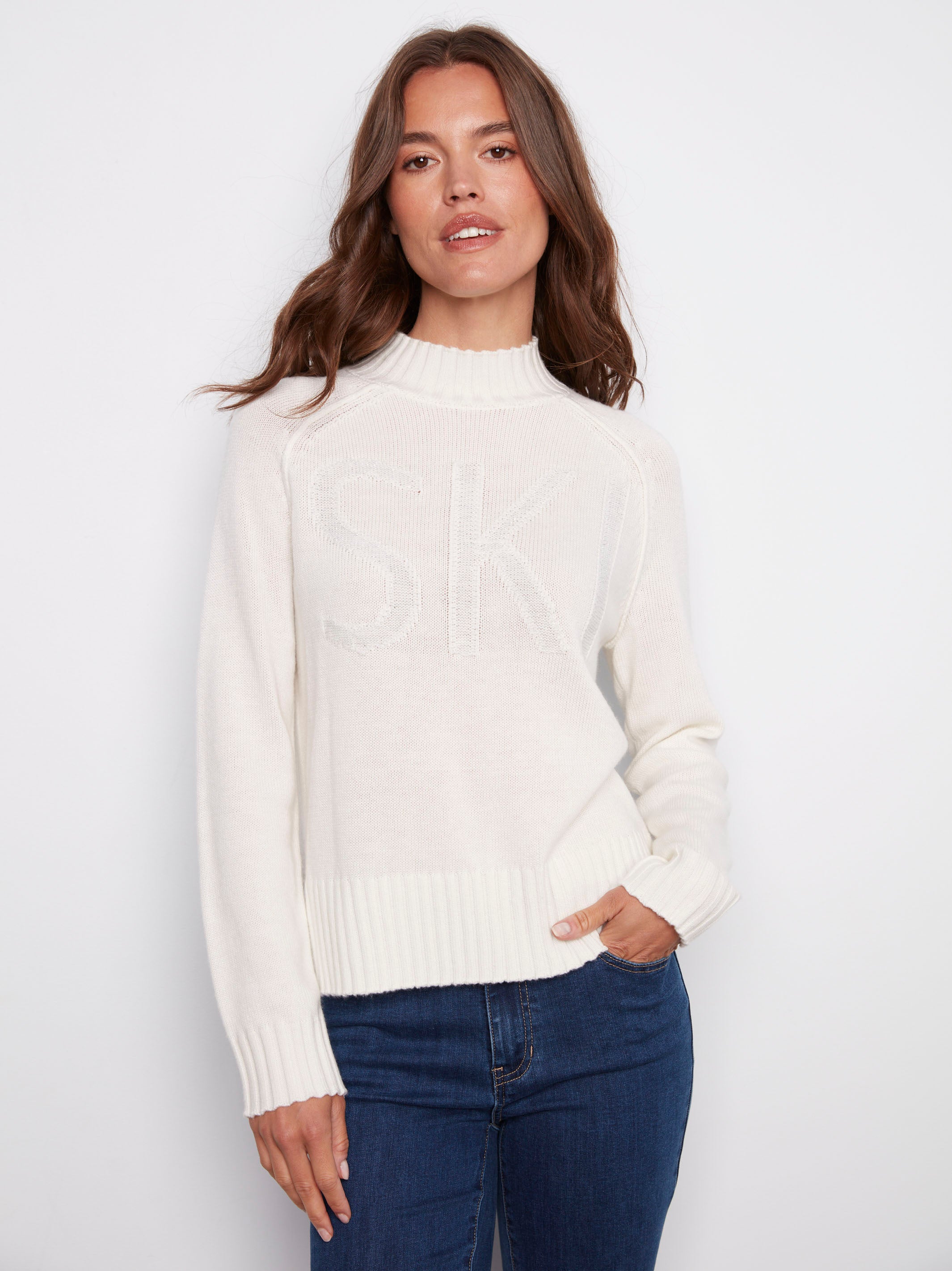 Ecru jacquard sweater featuring a mock neck and ribbed hem, highlighted by subtle metallic detail. Perfect for winter outings by Charlie B.