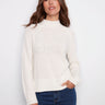 Ecru jacquard sweater featuring a mock neck and ribbed hem, highlighted by subtle metallic detail. Perfect for winter outings by Charlie B.