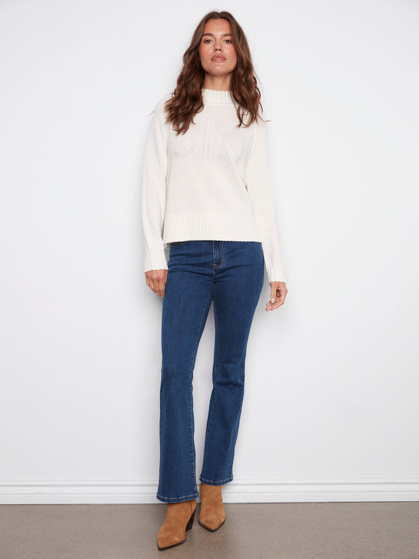 Stylish ecru sweater with 'SKI' graphic design and comfortable raglan sleeves, perfect for layering in cold weather by Charlie B.