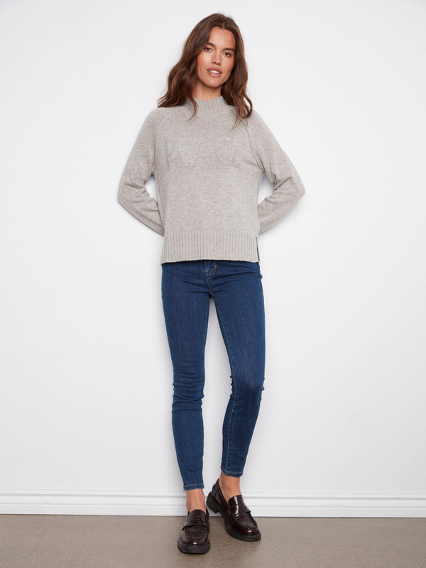 Stylish light grey sweater with ribbed hem, mock neck, and subtle metallic accents for a chic look by Charlie B.