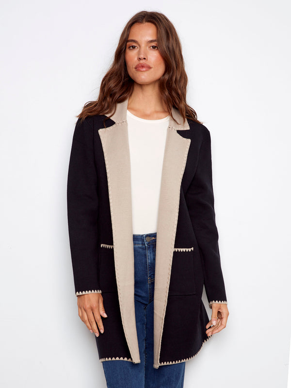 Black cardigan featuring a stylish contrast interior and elegant patch pockets by Charlie B.