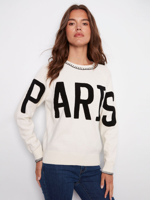 Cozy white sweater showcasing 'PARIS' in boucle embroidery, complete with a classic crew neck design by Charlie B.