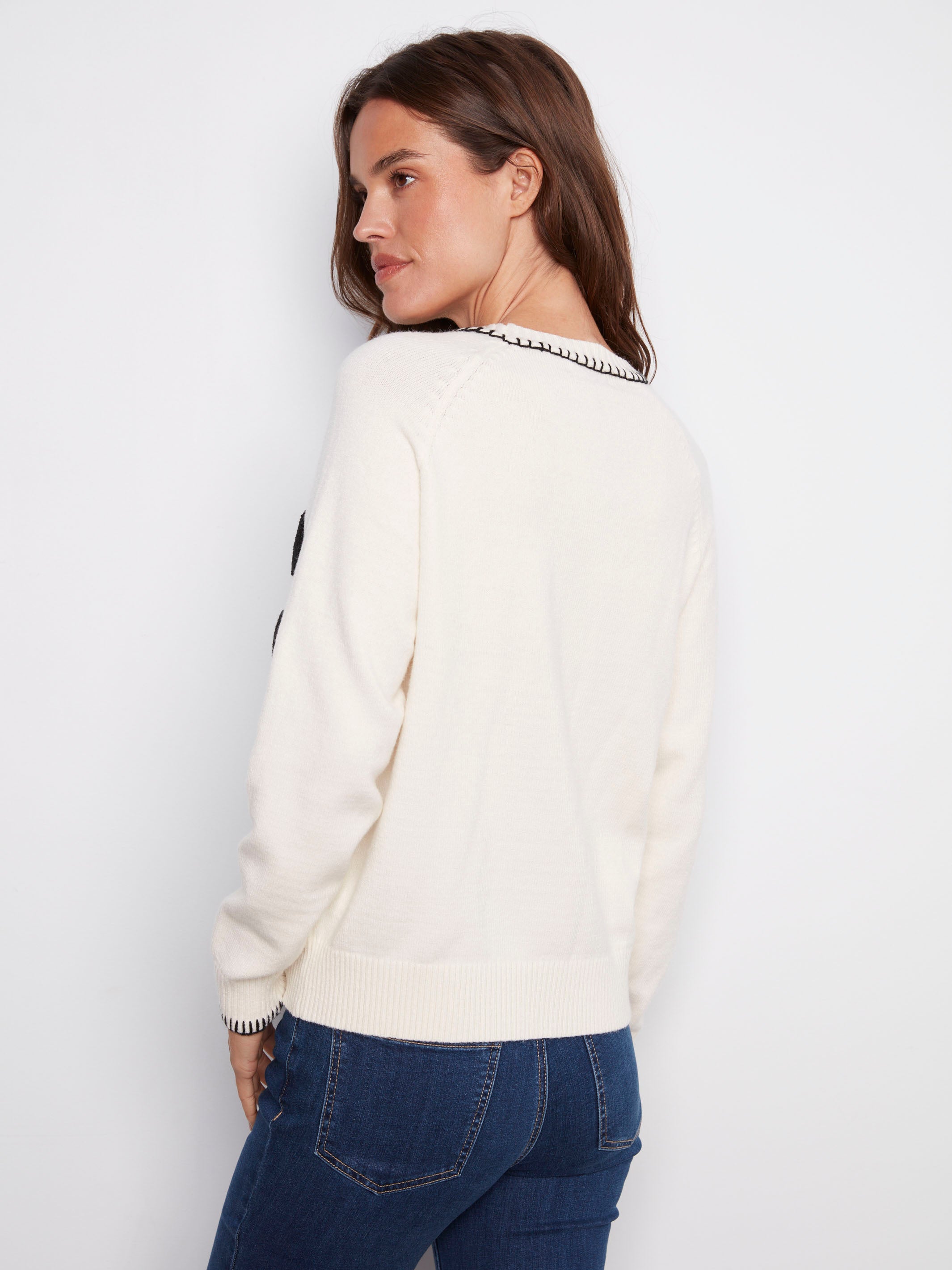 Elegant white sweater adorned with 'PARIS' in boucle embroidery and finished with delicate blanket stitch detail by Charlie B.