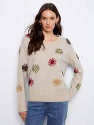 Sweater with a V-neck design, featuring elegant floral embroidery for a touch of charm. Crafted by Charlie B.