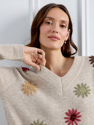 Embellished with colorful flowers, this cozy sweater combines style and warmth seamlessly. Created by Charlie B.