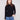 Black slim fit sweater paired with blue jeans, showcasing a stylish mock neck by Charlie B.