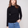 Black slim fit sweater paired with blue jeans, showcasing a stylish mock neck by Charlie B.