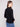 Elegant mock neck black sweater combined with blue denim for a chic look by Charlie B.