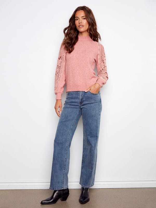 This beautiful primrose sweater combines style with comfort through its mock neck and exquisite design by Charlie B.