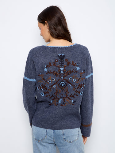 The embroidered back design adds a unique and artistic flair to this cozy sweater, making it a standout piece by Charlie B.
