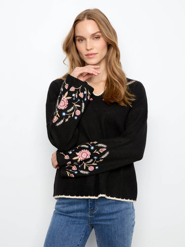 Sweater in black with long wide sleeves, showcasing detailed floral embroidery by Charlie B.