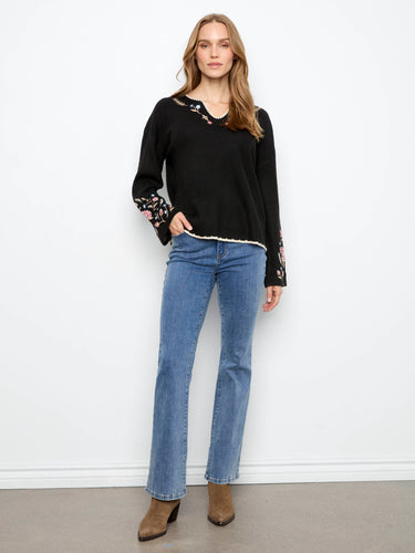 Stylish black sweater with intricate floral embroidery on the sleeves, made from ribbed knit by Charlie B.