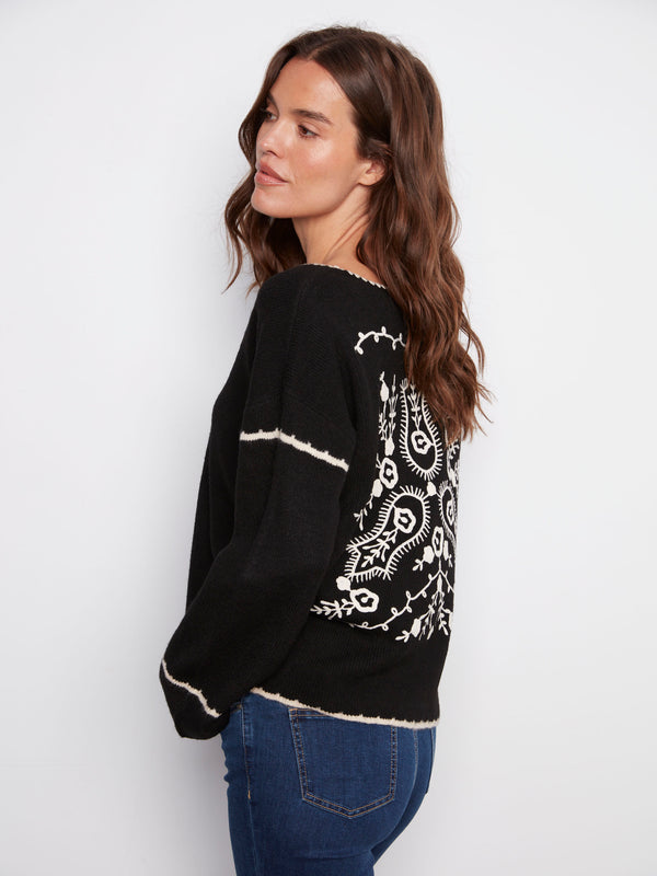 Elegant black sweater with ribbed texture and intricate white embroidered back design by Charlie B.