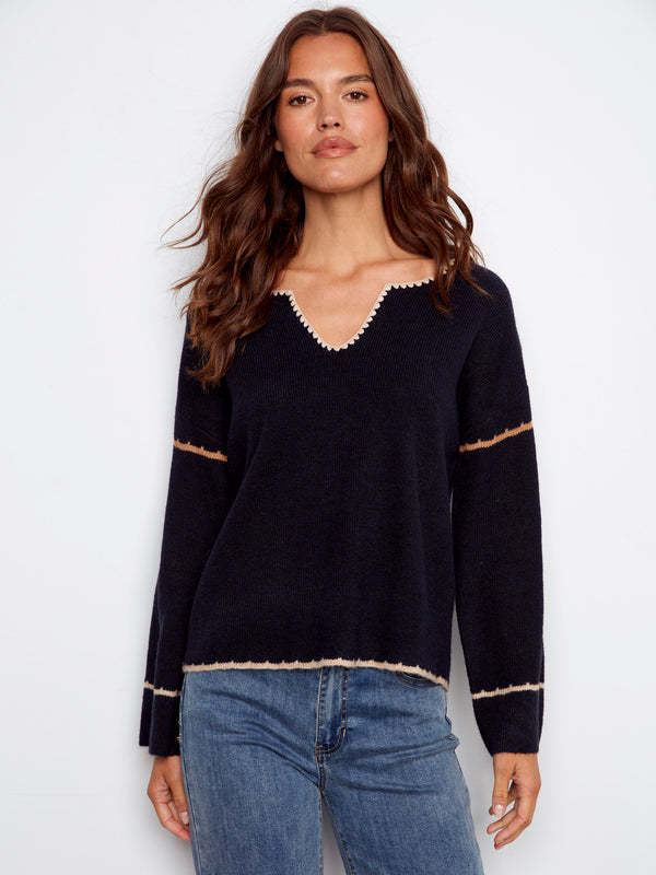 Navy sweater featuring drop shoulders and white embroidery detailing for a relaxed look by Charlie B.