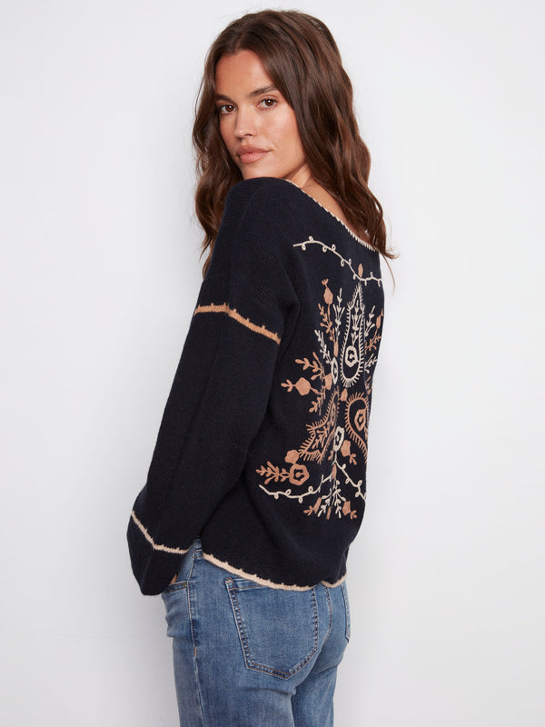 Sweater with ribbed texture and intricate white embroidery on the back, offering elegance by Charlie B.