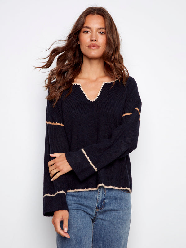 Ribbed navy sweater showcasing drop shoulders, perfect for casual elegance by Charlie B.
