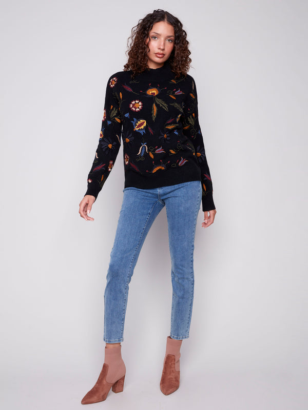 Chic black sweater with vibrant embroidered details and cozy ribbed cuffs for a stylish look by Charlie B.