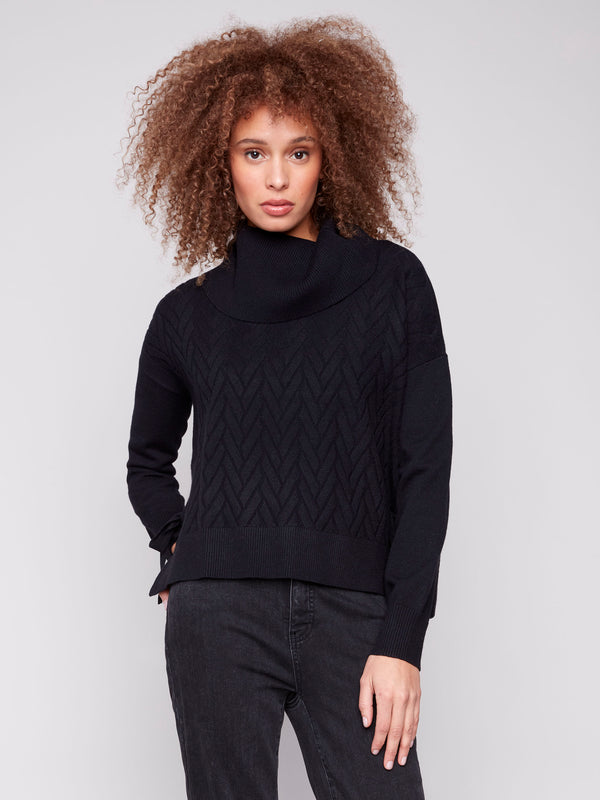 Black sweater with cowl neck and drop shoulders, featuring a chevron pattern. Designed for comfort and style by Charlie B.