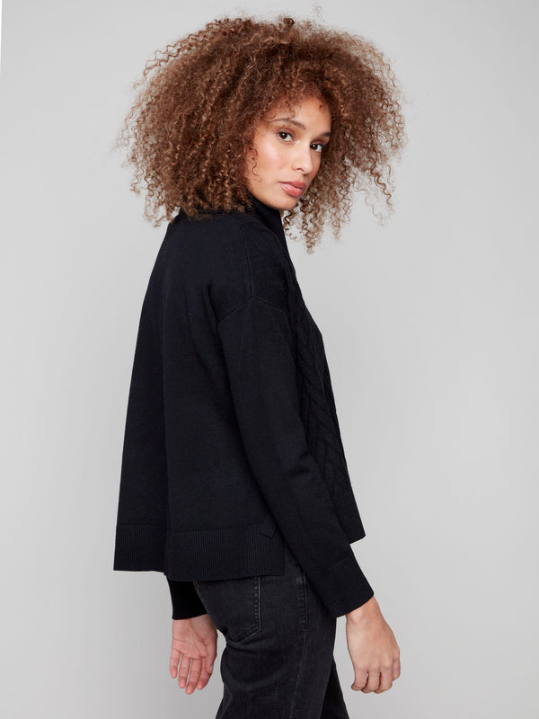 Elegant black sweater with ribbed cuffs and a chic chevron design. Perfect for layering or wearing alone by Charlie B.