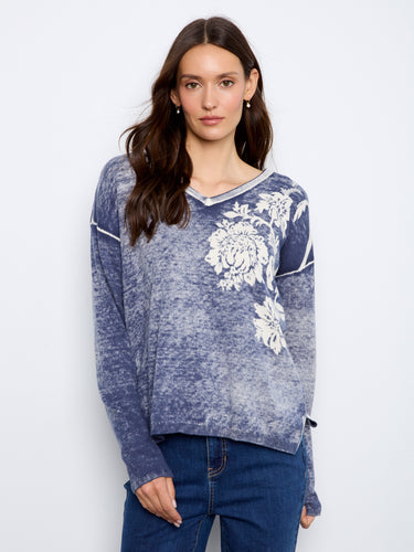 This sweater features a V-neck design with a cotton blend fabric, offering both style and comfort. By Charlie B.