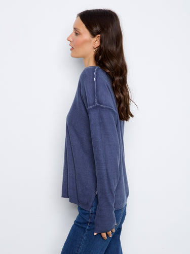 This garment showcases a V-neckline that adds elegance to any ensemble. By Charlie B.