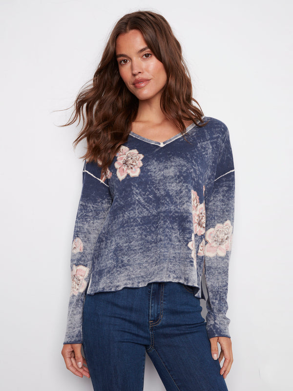 Denim blue sweater with a relaxed fit and floral accents, showcasing long sleeves for a cozy feel, by Charlie B.