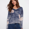 Denim blue sweater with a relaxed fit and floral accents, showcasing long sleeves for a cozy feel, by Charlie B.