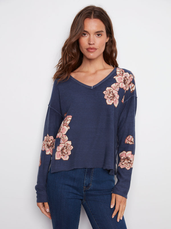 Floral printed V-neck sweater in denim blue, highlighting its reversible design for versatile wear, by Charlie B.