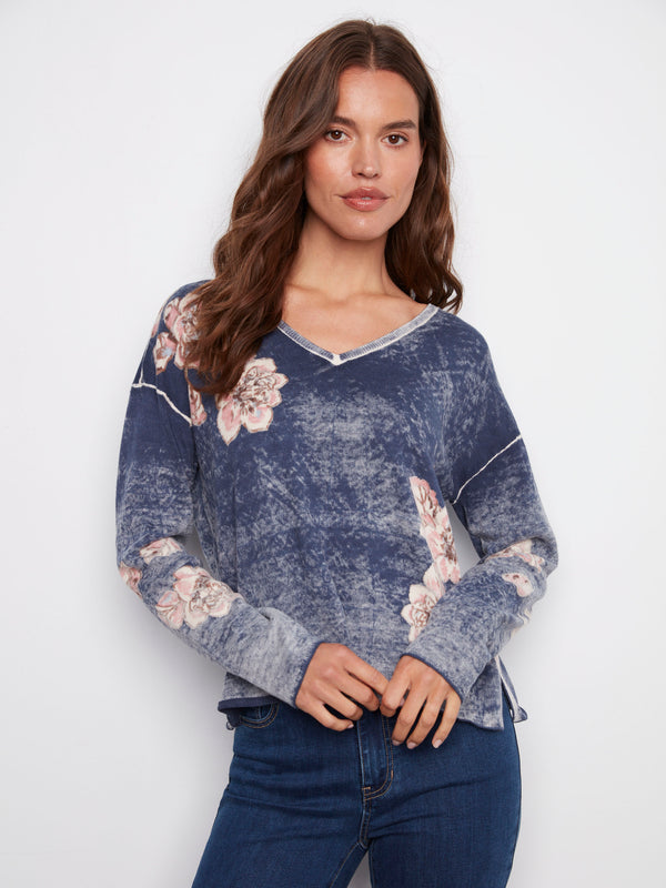 V-neck denim sweater adorned with soft floral prints and designed with a comfortable relaxed fit, by Charlie B.