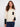 Ecru sweater featuring a classic crew neck design, highlighted by its stylish contrast black pocket by Charlie B.