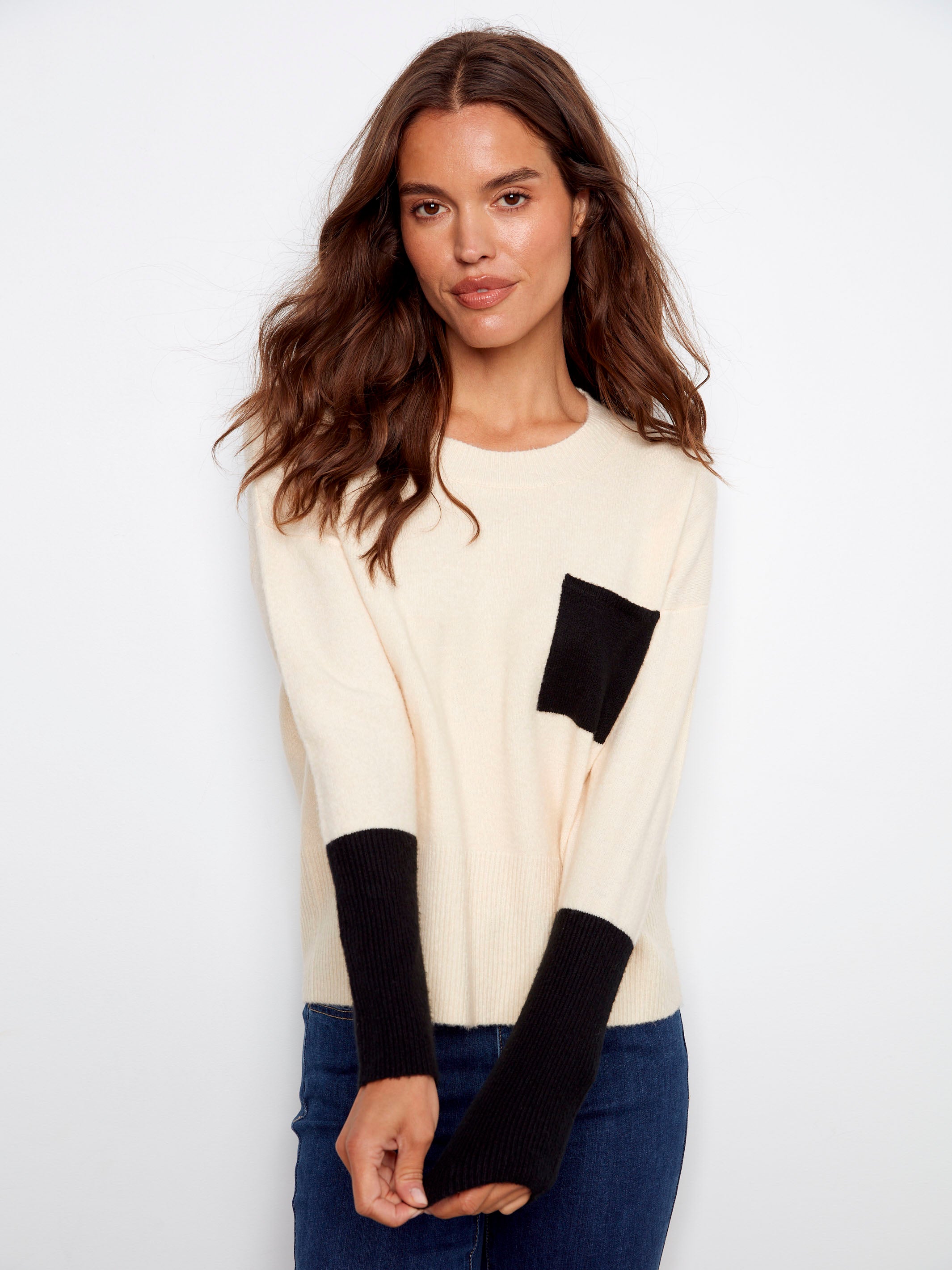 Ribbed sleeve cuffs in contrasting black give this ecru sweater an elegant finish and unique style by Charlie B.